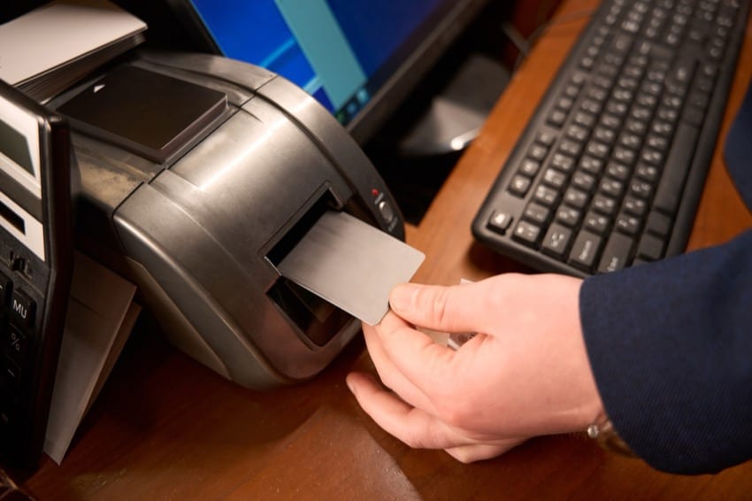 Freshly printed card coming out of a card printer